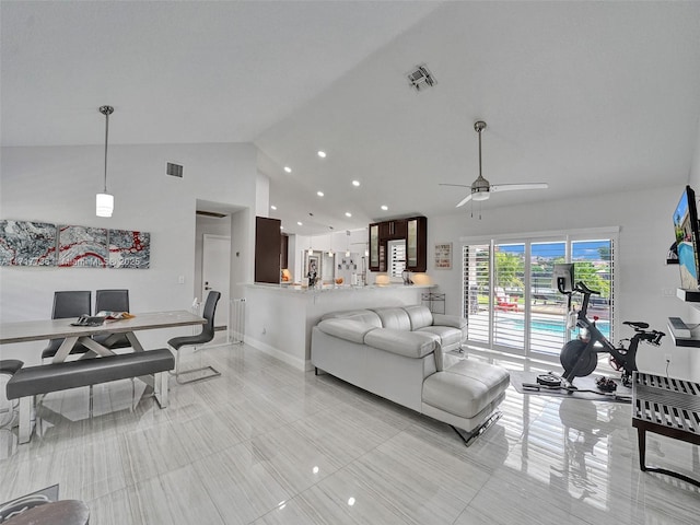 tiled living room featuring ceiling fan and vaulted ceiling