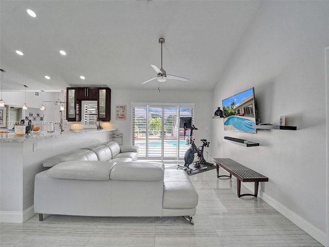 tiled living room featuring ceiling fan and lofted ceiling