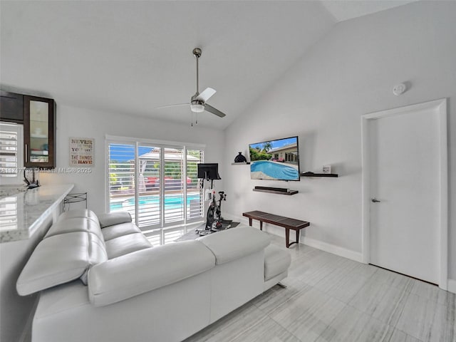 living room featuring ceiling fan and high vaulted ceiling