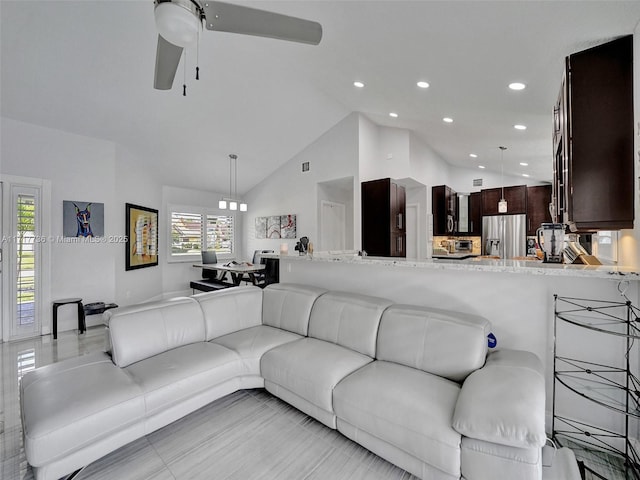 living room with high vaulted ceiling and ceiling fan