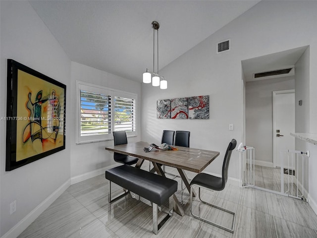 dining room with lofted ceiling and an inviting chandelier