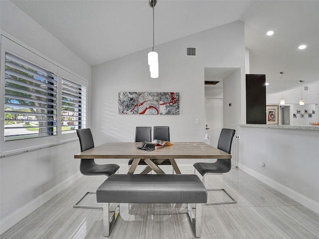 dining area featuring vaulted ceiling