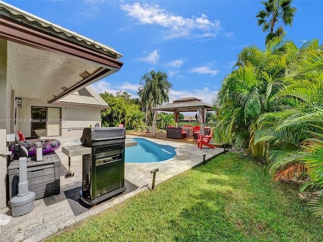 view of swimming pool featuring outdoor lounge area, a gazebo, a grill, and a lawn