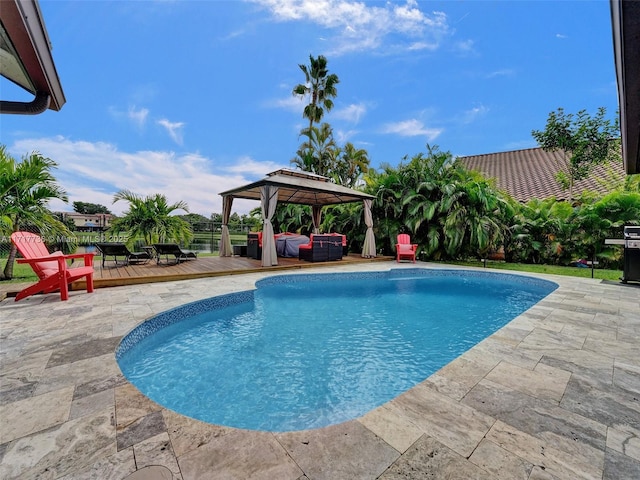 view of pool with a gazebo, a patio area, and a wooden deck