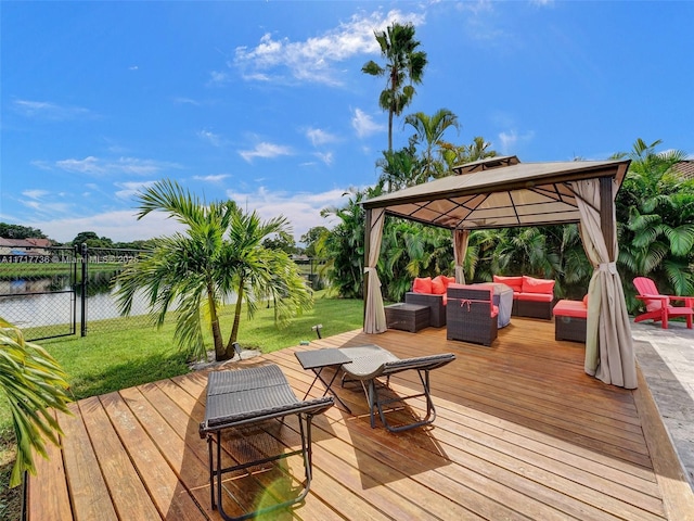 deck with a gazebo, a lawn, a water view, and an outdoor hangout area