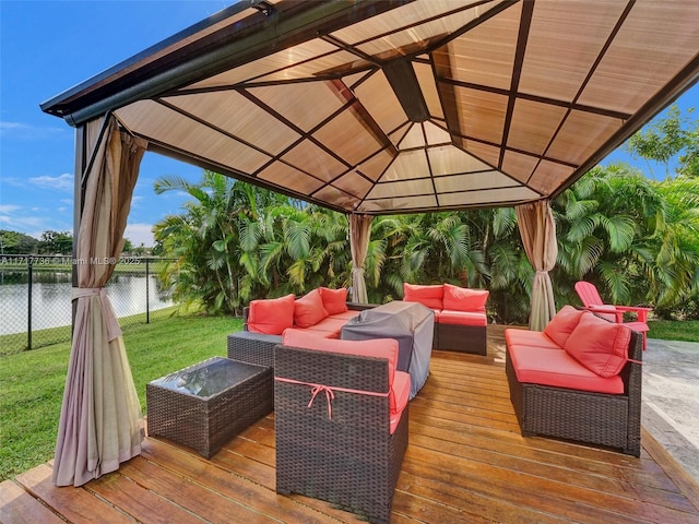 wooden deck with outdoor lounge area, grilling area, a water view, a gazebo, and a yard