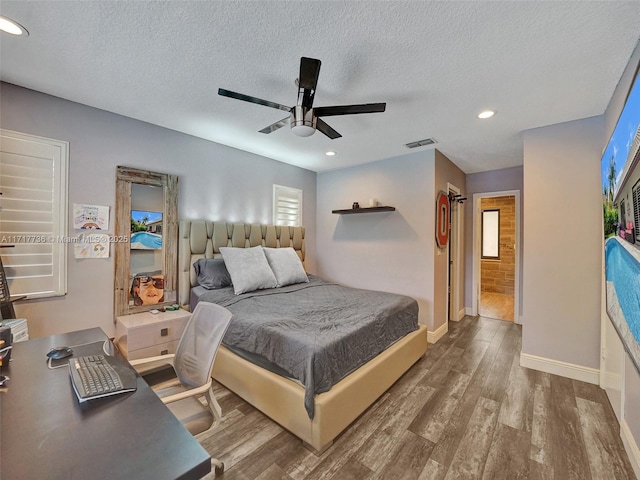 bedroom with hardwood / wood-style flooring, ceiling fan, and a textured ceiling