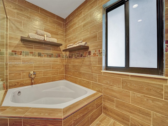 bathroom featuring tiled bath