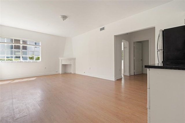 unfurnished living room with light hardwood / wood-style flooring