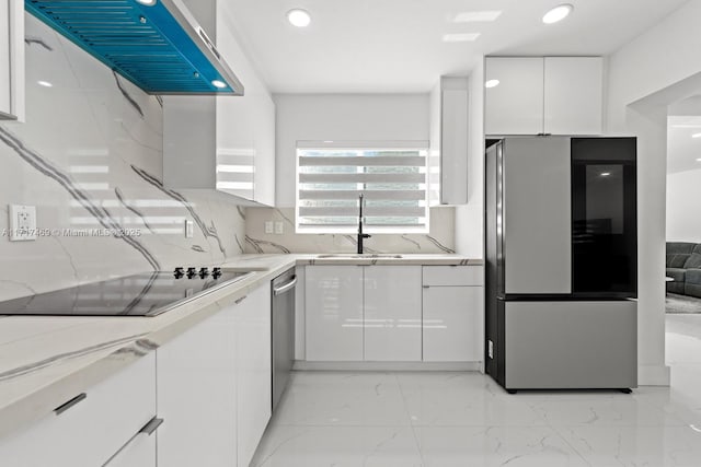 kitchen featuring extractor fan, stainless steel appliances, white cabinetry, and sink