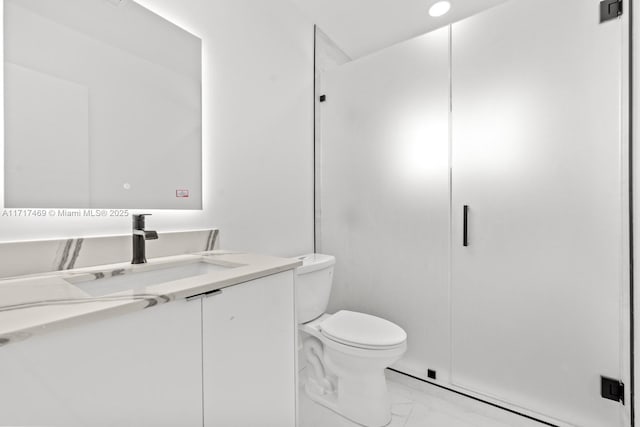 bathroom featuring vanity, toilet, and walk in shower