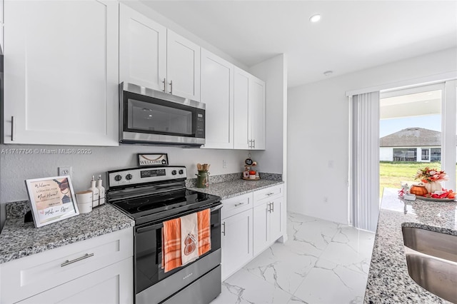 kitchen with appliances with stainless steel finishes and white cabinetry