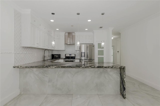 kitchen with wall chimney exhaust hood, stainless steel appliances, kitchen peninsula, pendant lighting, and white cabinets