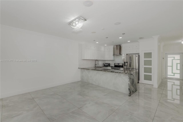 kitchen with white cabinets, wall chimney range hood, light stone counters, kitchen peninsula, and stainless steel appliances