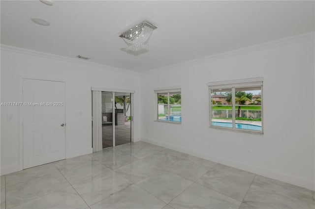 unfurnished room with crown molding and light tile patterned flooring