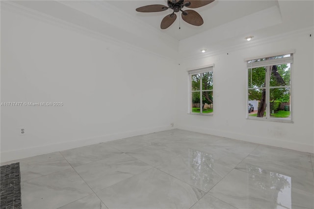 unfurnished room featuring ceiling fan, ornamental molding, and a tray ceiling