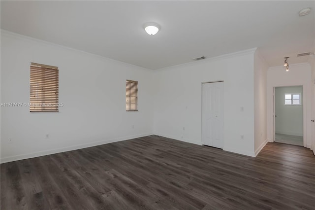 unfurnished room featuring crown molding and dark hardwood / wood-style flooring