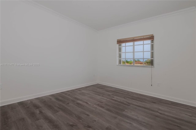 spare room with crown molding and dark hardwood / wood-style floors