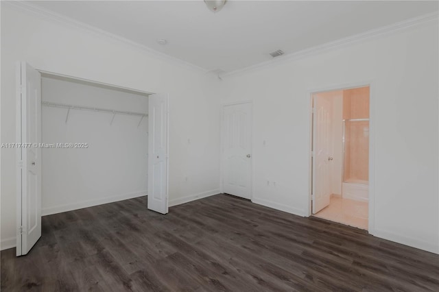 unfurnished bedroom featuring dark hardwood / wood-style flooring, ensuite bath, a closet, and ornamental molding