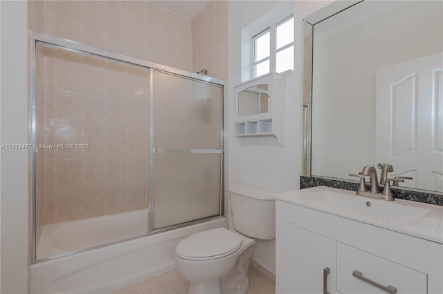 full bathroom featuring tile patterned floors, vanity, toilet, and enclosed tub / shower combo