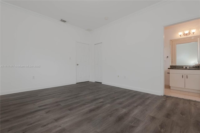 unfurnished room with dark hardwood / wood-style flooring, ornamental molding, and sink