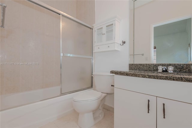 full bathroom featuring shower / bath combination with glass door, tile patterned floors, vanity, and toilet