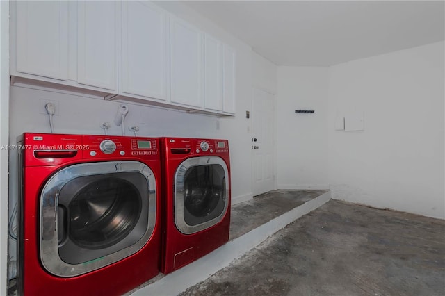 laundry area with washing machine and dryer and cabinets