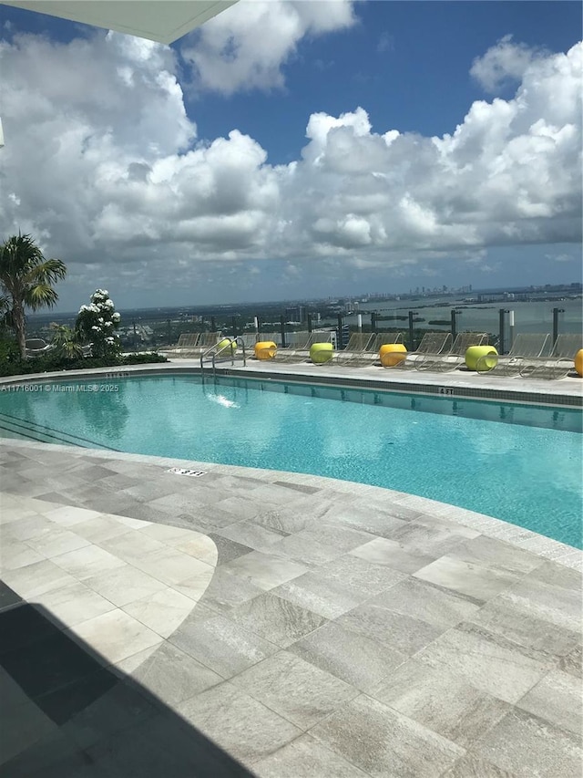 view of swimming pool featuring a patio