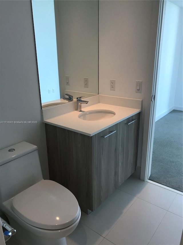 bathroom featuring tile patterned floors, vanity, and toilet