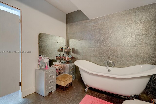 bathroom featuring a bath and tile walls