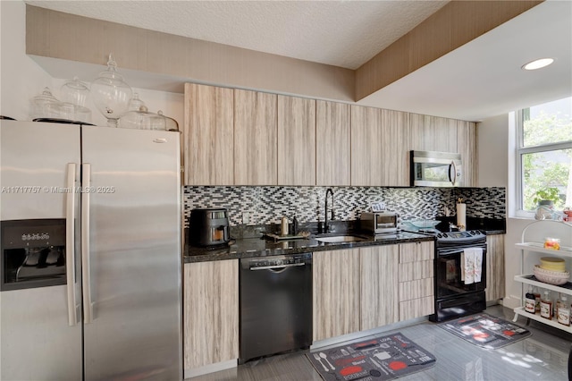 kitchen featuring black appliances, sink, and light brown cabinetry