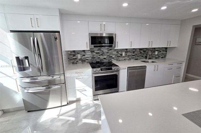 kitchen featuring sink, white cabinetry, decorative backsplash, and stainless steel appliances