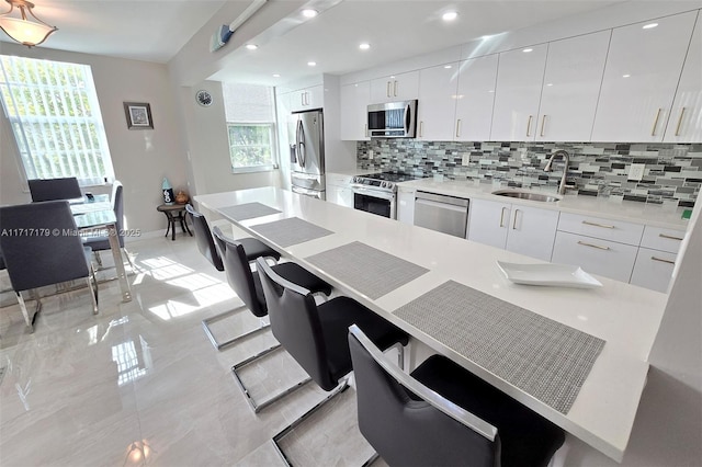 kitchen with white cabinets, stainless steel appliances, and sink