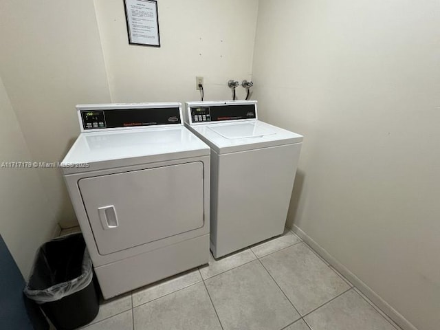 washroom featuring light tile patterned floors and separate washer and dryer