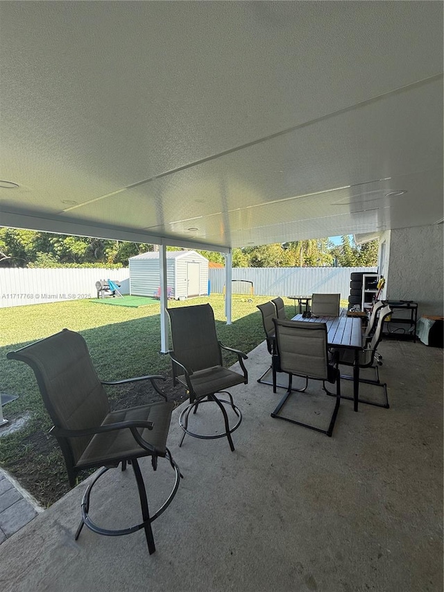 view of patio featuring a shed