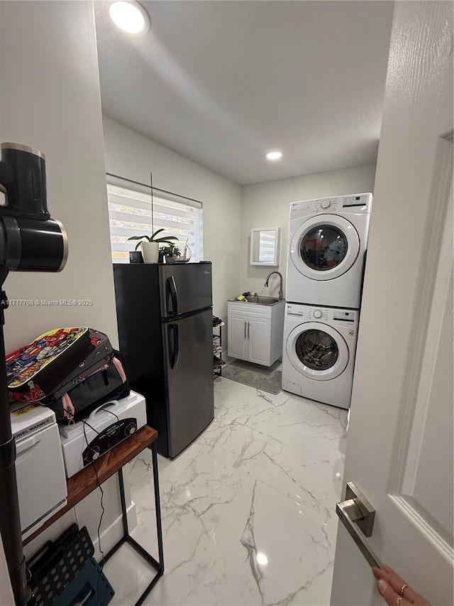 laundry area with sink and stacked washer / dryer