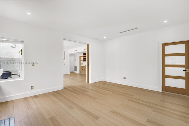 spare room with light wood-type flooring