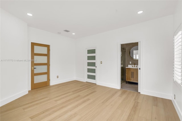 empty room with light hardwood / wood-style floors and sink