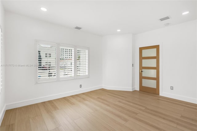 spare room with light hardwood / wood-style flooring