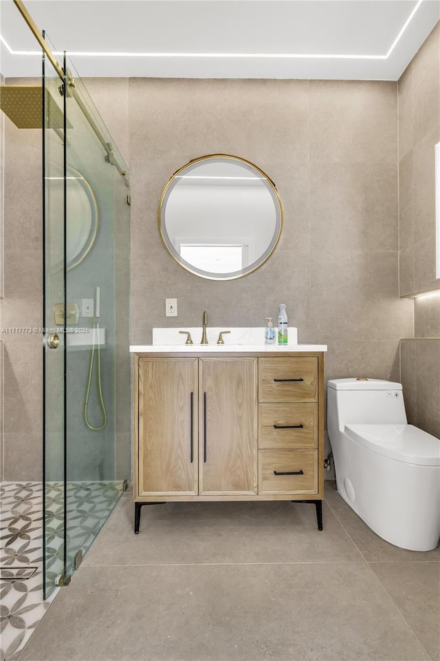 bathroom with tile patterned flooring, vanity, an enclosed shower, and toilet