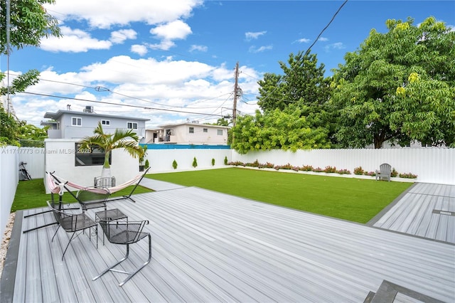 wooden terrace featuring a lawn