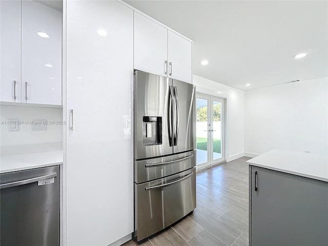 kitchen featuring white cabinets, stainless steel appliances, and french doors