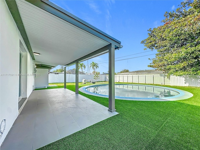 exterior space with a patio and a lawn