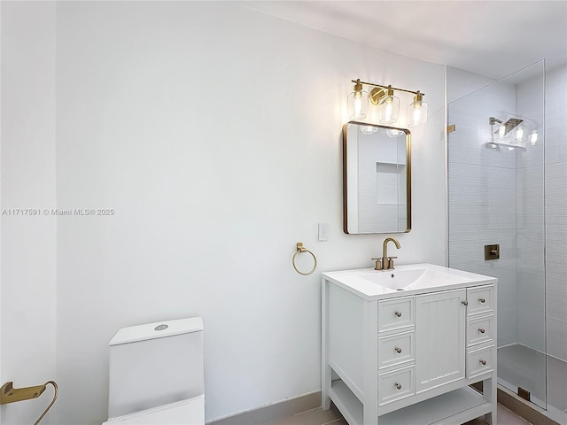 bathroom with toilet, vanity, and tiled shower