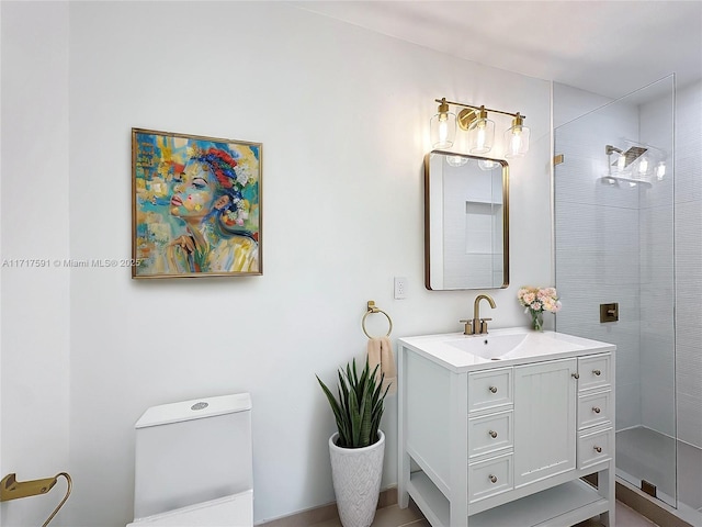 bathroom featuring toilet, vanity, and tiled shower