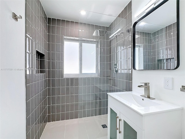 bathroom featuring vanity and tiled shower