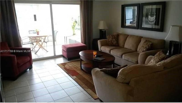 living room with a wealth of natural light and light tile patterned floors