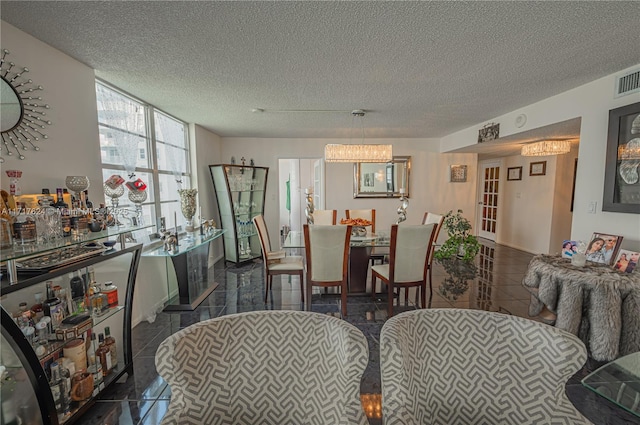 dining area with dark tile patterned flooring and a textured ceiling