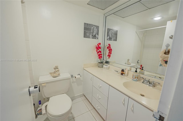 bathroom featuring tile patterned flooring, vanity, and toilet