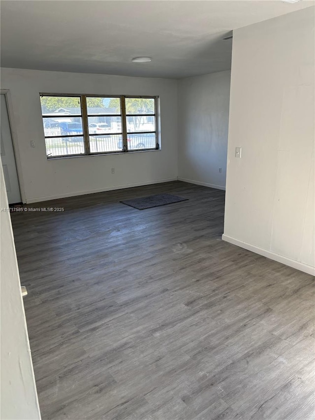 spare room featuring wood-type flooring